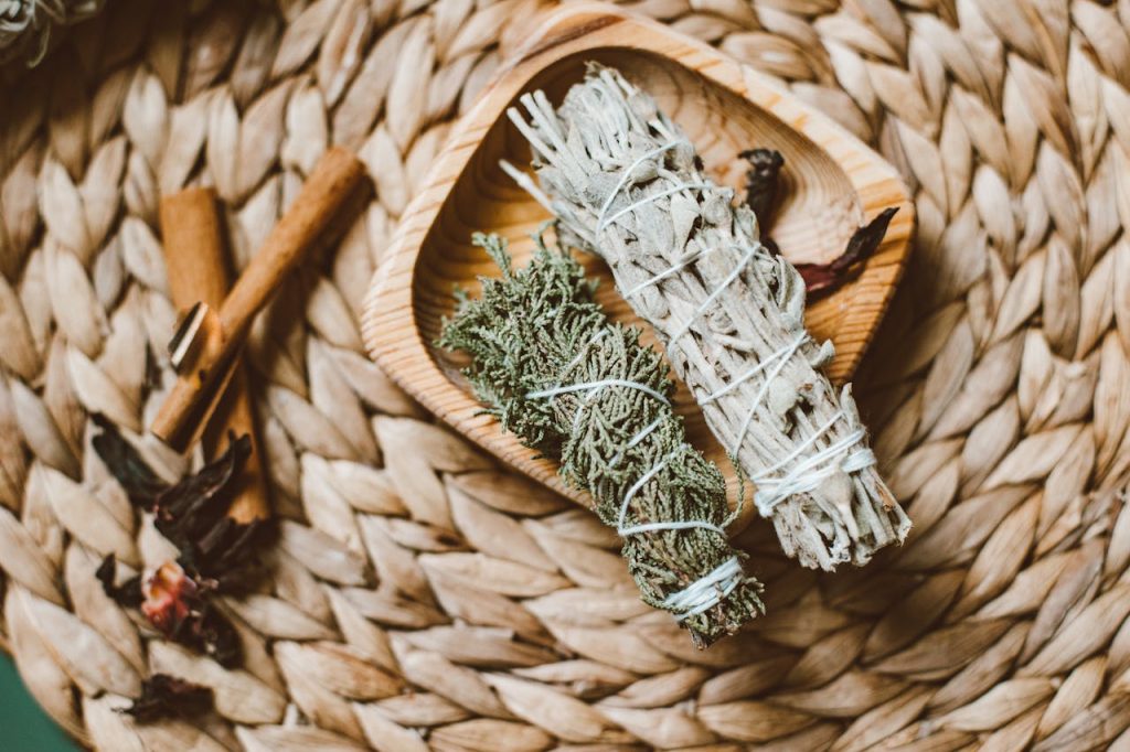 Mastering the First Impression: Your intriguing post title goes here Top view of herbal incense bundles and cinnamon on woven mat, evoking a natural aromatic ritual.